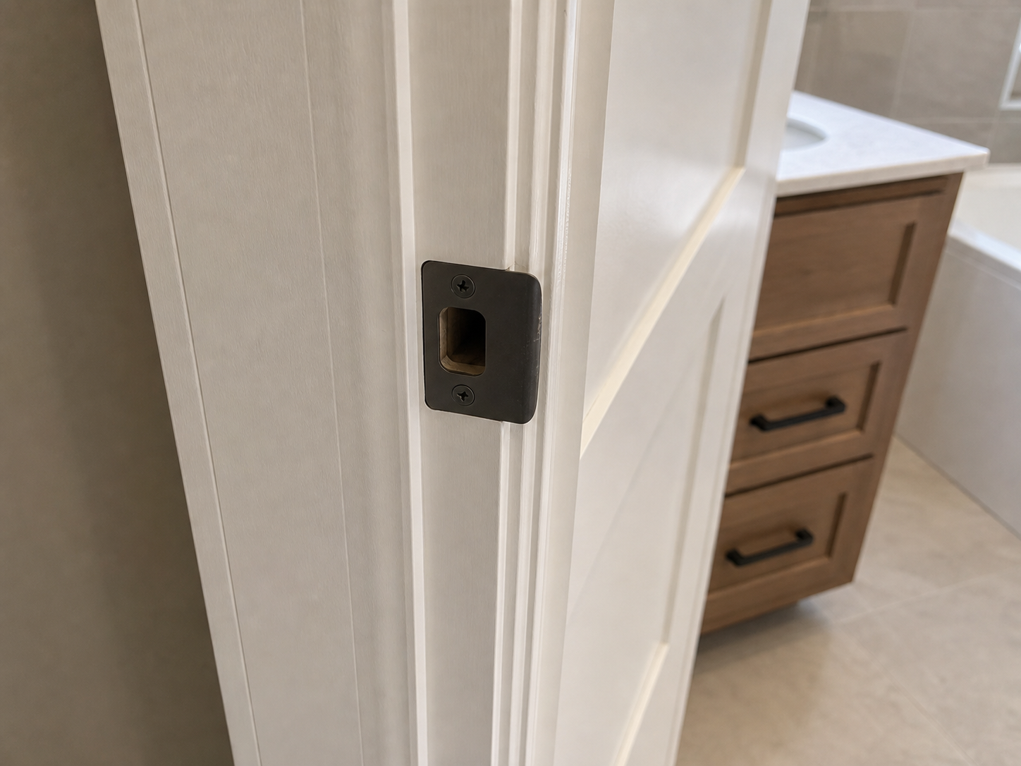 Misaligned bathroom door strike plate